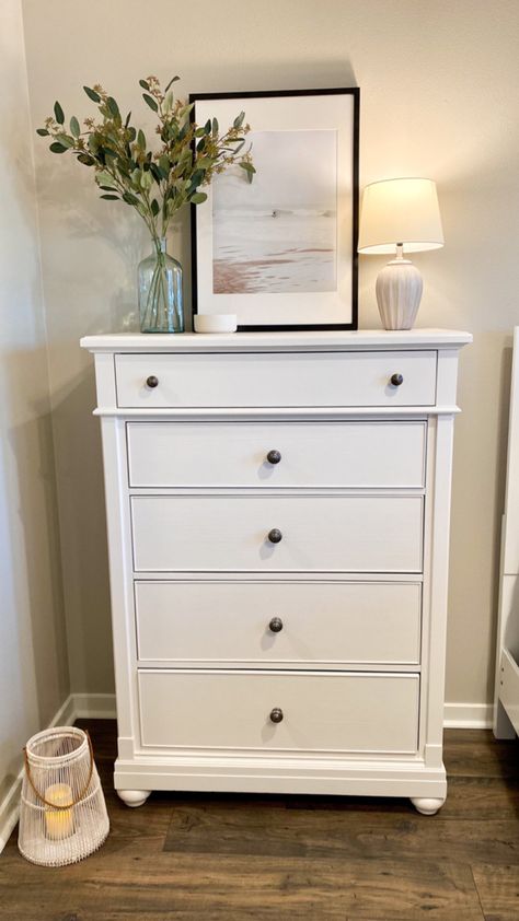 #talldresserdecor #bohocoastal #bedroomdecor #bedroomideas #moderncoastaldecor #coastalbedroom #decor #interiordecorating Bedroom Tall Dresser Decor Ideas, Chest Of Drawers Top Decor, Style Tall Dresser Top, Vertical Dresser Decor, White Dresser In Living Room, Styling A Tall Dresser Top, Y’all Dresser Decor, Tall Dresser Ideas Bedroom, Above Tall Dresser Decor