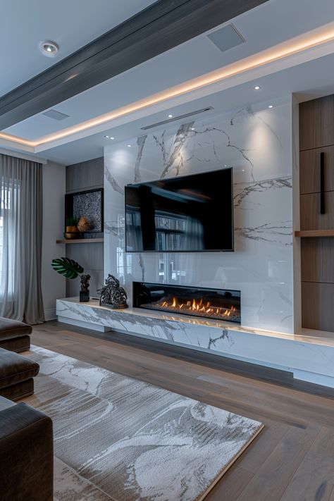 Revamp your living space with stylish fireplace wall ideas featuring a wall-mounted TV. Check out more ideas in this article. Tile Entertainment Wall, Giant Fireplace Family Rooms, Lounge Decor Fireplace, Modern House Design Interior Living Rooms Fireplaces, Foyer Tv Mural, Living Room Fireplace With Tv Modern, White Fireplace Tv Wall, Accent Walls In Living Room With Tv And Fireplace, Linear Fireplace Marble