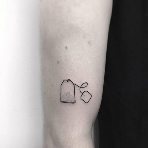 Teabag tattoo  Small black tattoo of a teabag inked on the right upper arm Small Black Tattoo, Small Tattoo Arm, Small Black Tattoos, Tea Tattoo, Stick And Pokes, Minimalist Tattoo Meaning, Stick Poke, Hamsa Tattoo, Shape Tattoo