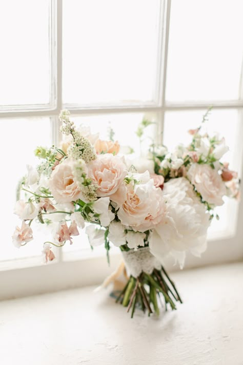 From the inspired hands of Doris Ione emerges a masterpiece: A bouquet interwoven with the softest hues of light pink and white, each petal and stem meticulously chosen to epitomize the pure essence of bridal grace, ensuring every bride feels as timeless as the love she celebrates. Light Pink Flowers Wedding, Light Pink Bouquet, Greenery Bridal Bouquet, Bridal Bouquet Peach, White Bridal Flowers, Vintage Bridal Bouquet, Lifestyle Studio, Bright Wedding Flowers, Pink And White Weddings