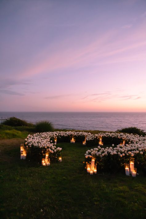 On the dreamiest summer evening in Malibu, set against the backdrop of the most perfect sunset, the Santa Monica Mountains, and the glistening Pacific Ocean, the newly engaged couple said ‘Yes’ to forever in one of the most romantic surprise proposals I have yet to witness (and photograph). Proposal Photography, Beach Proposal, Luxury Proposal, Malibu Proposal Proposal Ideas Tangled, Luxury Engagement Proposal, Disney Themed Proposal Ideas, Eloping Ideas Destinations, Wedding On A Cliff, Intimate Wedding Proposals, Field Of Flowers Proposal, Simple Elegant Proposal Ideas, Scenic Proposal Ideas