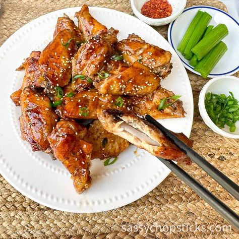 Baked Asian chicken wings are a delicious appetizer or snack that features chicken wings seasoned with Asian flavors and then baked in the oven. These wings typically involve a marinade made with ingredients commonly found in Asian cuisine, such as soy sauce, ginger, garlic, sesame oil, etc. They are a popular choice for those who enjoy the diverse and exciting flavors of Asian cuisine and the classic appeal of chicken wings. Believe me, once baked, they will disappear quickly!  Ingr… Asian Wings Recipe Oven Baked, Chicken Wings Asian Style, Asian Style Wings, Crispy Baked Asian Chicken Wings, Air Fryer Chicken Wings Asian Zing, Chicken Wing Seasoning, Asian Chicken Wings, Chicken Drums, Pan Fried Dumplings