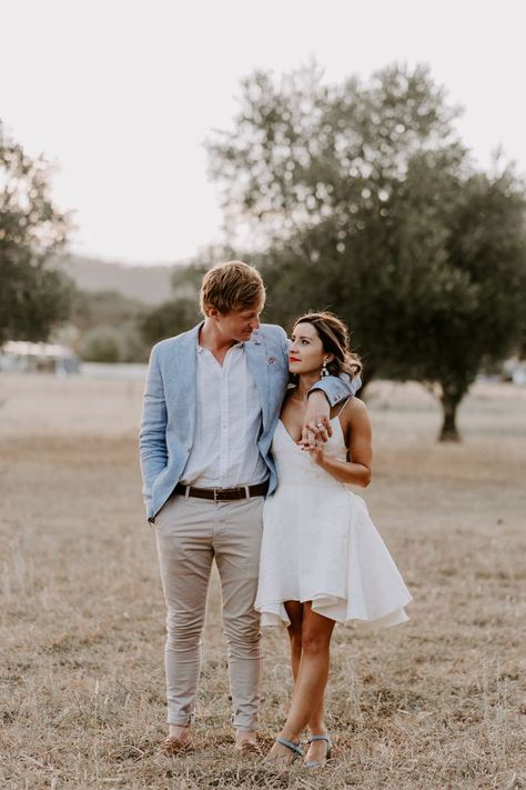 Casual and laidback wedding outfit ideas with the groom in khakis and a light blue blazer and the bride in a short and strappy wedding dress Beach Wedding Suits For Men Blue, Summer Wedding Groom Attire Casual, Groom Summer Wedding Attire, Summer Groom Attire, Strappy Wedding Dress, Casual Wedding Groom, Laidback Wedding, Beach Wedding Groom Attire, Casual Wedding Outfit