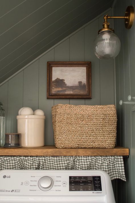 Laundry room transformation from boring and beige to moody and beautiful. Painted Paneling Laundry Room, Colonial Style Laundry Room, Laundry Room Wall Organization Ideas, Laundry Closet Farmhouse, Folding Table Above Washer And Dryer, Laundry Room Silver Appliances, Shelf Under Cabinet Laundry Room, Homestead Laundry Room, Laundry Room Crafts