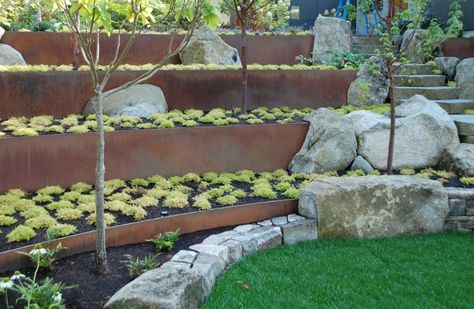 If you’re using planters near vegetable, avoid toxic lead as they can cause damage Cheap Retaining Wall, Steel Retaining Wall, Boulder Garden, Terraced Garden, Retaining Wall Design, Retaining Wall Ideas, Terraced Landscaping, Landscaping A Slope, Northwest Landscaping