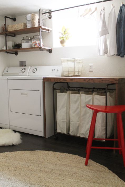 basement laundry room -- I like the simplicity of this room, the wooden folding table, the shelves over the washer/dryer, the drying rack, the laundry sorter under the table (genius, then you don't have to see the messy laundry!), and the bright red stool Functional Basement, Laundry Room Organization Storage, Room Storage Diy, Casa Clean, Basement Laundry Room, Basement Laundry, Laundry Room Bathroom, Farmhouse Laundry Room, Small Basements