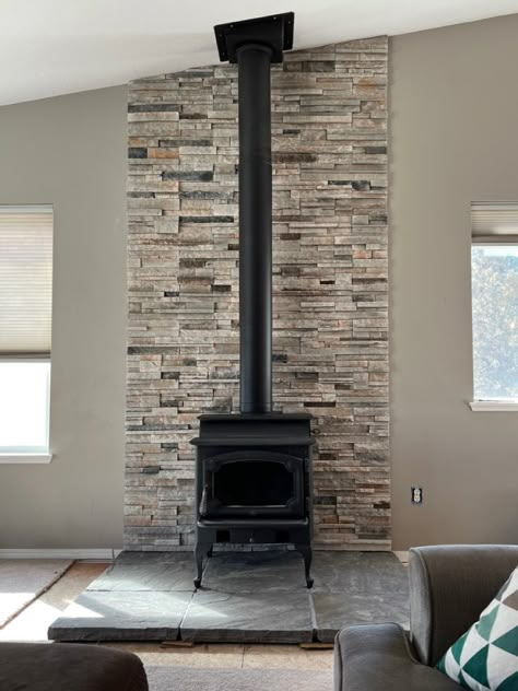 Stone Wood Stove Hearth, Wood Stove Surround Flat Wall, Wood Stove Center Wall, Stone Behind Wood Burning Stove, Stone Wall Behind Wood Stove, Pellet Stove Back Wall, Wall Behind Pellet Stove Ideas, Behind Wood Stove Wall, Wood Stove Stone Wall