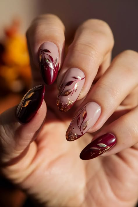 Step into the season with stunning almond nails that capture the essence of Fall! This nail style combines pretty autumn hues with elegant designs, making it a perfect choice for casual outings or classy events. Think deep burgundy, rich mustard, and earthy greens, all enhanced with funky nail art or subtle rhinestones. Whether you choose gel nails or acrylic, these almond nails will elevate your look beautifully. #AlmondNails #NailInspo #FallNails #NailArt #ElegantNails Maroon Almond Nails Design, Almond November Nails, Burgundy Floral Nails, Maroon Almond Nails, November Almond Nails, Almondetto Nails, Almond Nails Autumn, Red Wedding Nails, Burgundy Nail Designs