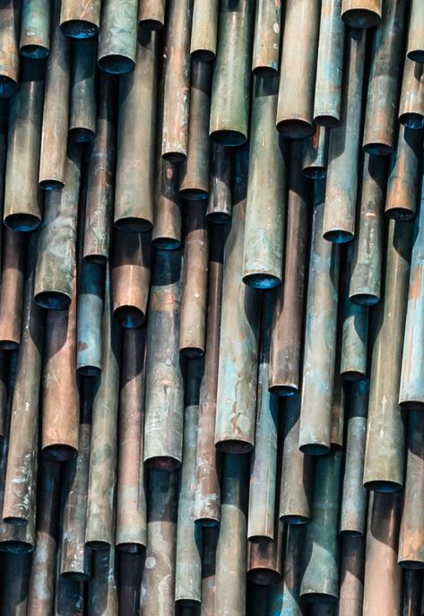 Designer Raphael Navot has used oxidised copper tubes to create a unique and interesting accent wall in a restaurant within a hotel. #AccentWall #Copper #Design Copper Feature Wall, Copper Panels Interior, Black And Copper Restaurant, Bar Accent Wall, Copper Pipe Art, Copper Wall Tiles, Copper In Architecture, Sea Architecture, Unique Accent Wall