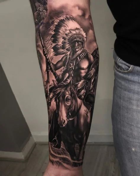 105+ Native American Tattoo Ideas To Honor Indigenous Heritage Native American Tattoos Back Piece, Native American Realism Tattoo, Indian Themed Tattoos, Native Forearm Tattoo, Eagle Tattoo Native American, Cowboy Arm Sleeve Tattoos, Native Eagle Tattoo, Native American Back Tattoos, Cowboys And Indians Tattoo