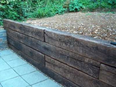 railway sleeper retaining wall - Google Search Railroad Tie Retaining Wall, Sleeper Wall, Sleeper Retaining Wall, Sleepers In Garden, Wood Retaining Wall, Retaining Wall Design, Building A Retaining Wall, Garden Retaining Wall, Rustic Backyard