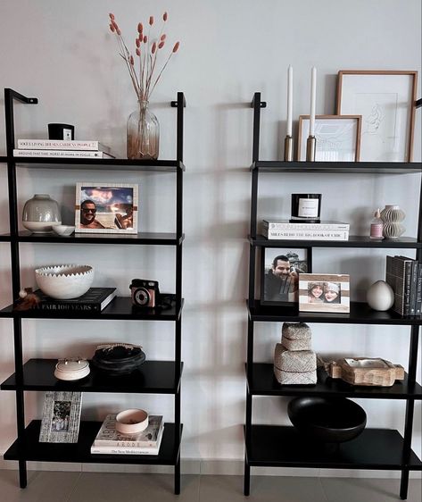 Black Bookshelf Decor Living Room, Cb2 Ladder Shelf, Books In Small Apartment, Steel Shelves Design, Black Ladder Shelf Decor, Decorating Black Bookshelves, Black Shelf Decor Living Room, Ladder Bookshelf Styling, Ladder Shelf Styling