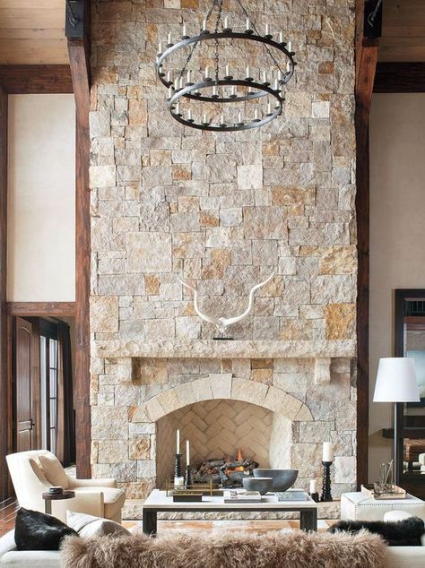 a neutral farmhouse living room with a stone fireplace, elegant creamy furniture and a statement chandelier New Build Fireplace, Ski Lodge Fireplace, Mountain Craftsman Style Homes, Low Fireplace, Whitewash Stone Fireplace, Lodge Fireplace, Chalet Living Room, Fireplace Wedding, Chic Living Room Ideas