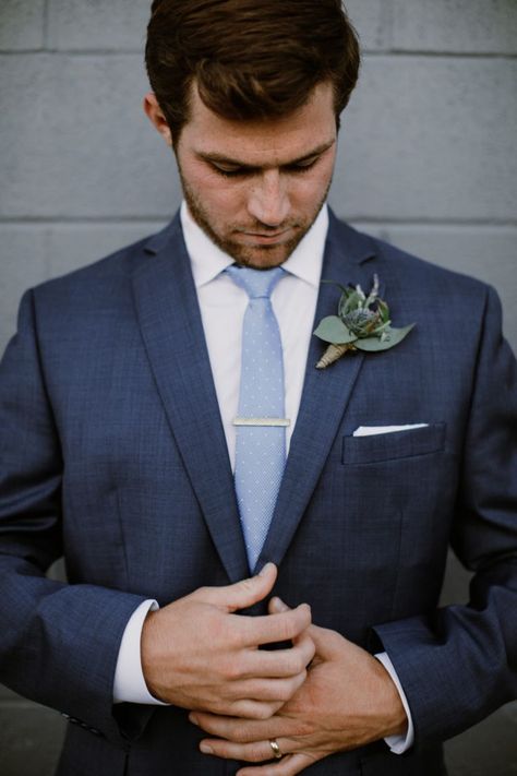 Handsome groom in dark navy suit getting ready before the ceremony. Navy blue suit looks good paired with light blue tie. #navysuit #groomattire #smokyhollowwedding Light Blue Tie With Navy Suit, Blue Suit Blue Tie Wedding, Navy Blue Suit Light Blue Tie, Tie With Navy Blue Suit, Navy Suit With Blue Tie, Navy Blue Suit With Light Blue Tie, Navy Suit Light Blue Tie, Dark Navy Blue Groomsmen Suits, Dark Blue Suit With Light Blue Tie