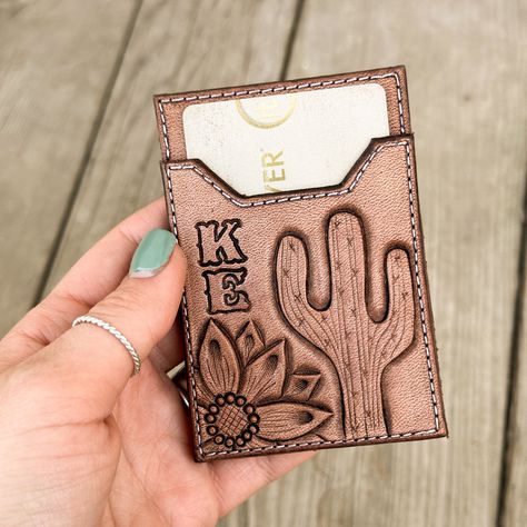 This wallet is designed to attach to the back of your phone or phone case to keep your cards, cash & ID all in one place.  Wallets come in one standard size that fits all larger phones. They measure 3 7/8 inches tall by 2 5/8 inches wide.  This item is handmade each time an order is placed, so the finished product may vary slightly from the photo. Tooled Leather Phone Case Western, Western Leather Projects, Leather Wallet Making, Quick Leather Projects, Cricut Leather Projects Ideas, Leather Work Designs, Beginner Leather Projects, Leather Phone Case Western, Tooled Leather Phone Case