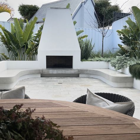 Loving this small backyard garden with custom built in seating that embraces the stunning outdoor fireplace 😍 The key to small space design is leading the eye to a focal point to deter the sense of limited space. Minimising furniture by designing creative solutions for seating areas is another great space saver and where possible adding green on the ground such as a small patch of lawn always gives the illusion of more space 💚 Soul Project @jennifer_newell_design Landscape Design @outside... Small Sunken Seating Area Garden, Built In Outdoor Seating, Landscape Fire Pit, Built In Garden Seating, Small Backyard Garden, Outside Fireplace, New Old House, Pool Landscape Design, Sunken Garden