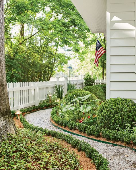 See This New Orleans Ranch's Classic Country Makeover | Southern Living Ranch Makeover, Side Yards, Farmhouse Landscaping, New Orleans Homes, White Picket Fence, Beautiful Dining Rooms, Side Yard, Picket Fence, Ranch Style