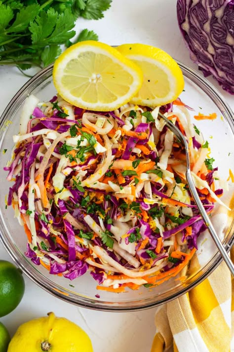 This sweet citrus slaw is a deliciously crisp, tangy and lightly sweet mix of green cabbage, red cabbage, and carrots topped with a bright blend of orange, lime, and lemon juice, olive oil, and maple syrup. This recipe has been a family favorite for folding into fish and shrimp tacos, layering into wraps and bowls, or pairing as a tart side with grilled burgers, chicken, or steak. #citrusslaw #citruscoleslaw #slaw #slawrecipe #cabbageslaw #bbqsidedish Citrus Coleslaw, Mexican Coleslaw Recipe, Citrus Slaw, Mexican Coleslaw, Slaw For Fish Tacos, Cabbage And Carrots, Lime And Lemon, Healthy Coleslaw, Grilled Cabbage