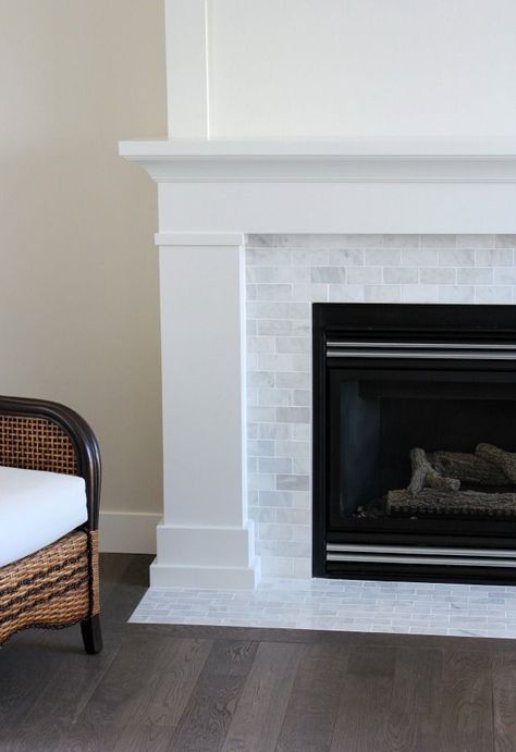 Our fireplace makeover is officially done! Come check out how we used inexpensive trim and marble subway tile to give it a fresh new look. Shaker Style Trim, Casa Rock, Fireplace Mantel Designs, Fireplace Redo, Fireplace Tile Surround, Mantel Design, Small Fireplace, Fireplace Built Ins, Marble Fireplace