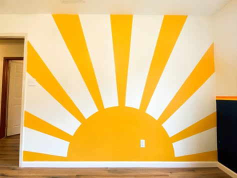 Yellow sunshine mural. Office mural. Sun accent wall. Playroom Sun Mural, Yellow Wall Murals Painted, Diy Sun Mural Wall, Daycare Accent Wall, Painted Sun Mural, Sunshine Wall Painting, Sunshine Accent Wall, Sun Wall Paint, Yellow Accent Wall Office