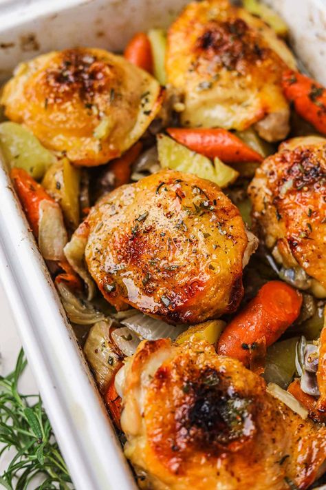 Roasted Chicken Thighs and Vegetables is an easy, hearty one-pan dinner recipe that results in crispy, juicy chicken and flavorful vegetables. Just toss the chicken, potatoes, onions, and carrots in mustard, honey, and olive oil, season, then roast in the oven until golden! Roasted Chicken Thighs And Vegetables, Roast Chicken Thigh Recipes, Oven Roasted Chicken Thighs, Chicken Thighs Dinner, Potatoes Onions, Hearty Dinner Recipes, Roasted Chicken Thighs, Flavorful Vegetables, Oven Roasted Chicken