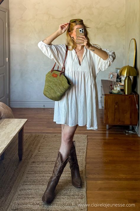 Found this super cute boho babydoll dress on Depop and styled it with my trustee brown leather cowboy boots and a raffia basket bag to go to a street festival. Loved the mesh of aesthetics. #springoutfitideas #festivaloutfitideas #coastalcowgirl #cowboybootsoutfit #raffiabag • how to style cowboy boots with a dress • how to style a babydoll dress • linen dress outfit ideas • Cowboy Boots Boho Outfit, Date Night Cowgirl Boots Outfit, Boho Dresses Casual, Cowboy Boot Outfit Aesthetic, Sun Dress With Boots, Cowgirl Boots With Skirts Outfit, Cowgirl Boots Outfit Brown, Heeled Cowboy Boots Outfit, Sundresses And Cowboy Boots