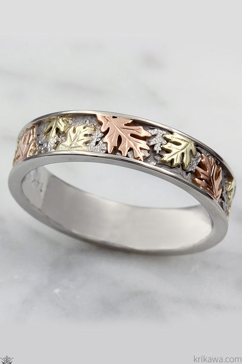 It's a magical time of year when the summer heat begins to wane, and cool breezes rustle through the trees. Leaves begin to turn from vibrant greens to warm hues of orange, yellow, and red. Capture that special time of year and keep it with you forever with this triple-tone oak leaf wedding band. 

Handcrafted in palladium, 14k rose gold, and 10k green gold. Wedding Bands And Engagement Rings, Leaf Wedding Band, Animals Flowers, Oak Leaves, Oak Leaf, Summer Heat, Green Gold, Nature Lovers, Tri Color