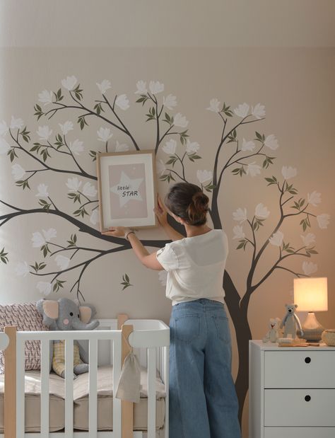 Suit up your kids' room with our unique Flowers Tree Wall Decal. This detailed, vibrant decal of magnolia flower drifting in the air will transform your empty, boring wall into a cozy nursery. Give your home a bold new look today! Floral Accent Wall Nursery, Nursery With Mural, Tree Painting On The Wall, Nursery Tree Mural, Nursery Wall Painting Ideas, Baby Room Wall Painting, Eloise Bedroom, Nursery Mural Ideas, Flower Nursery Theme