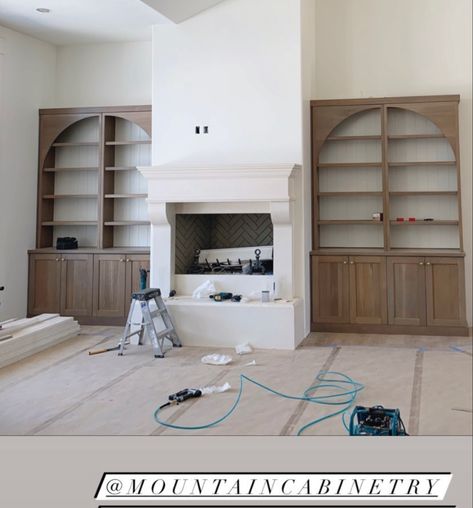 Curved Built Ins Around Fireplace, Arched Bookshelf Next To Fireplace, Fireplace Built Ins With Arches, Built In Shelves 2 Story Living Room, Built In Cabinets Living Room High Ceiling, Round Top Built In Bookcase, Display Cabinet Next To Fireplace, Built In Shelves Living Room Tall Ceilings, Built In Cabinet With Arch