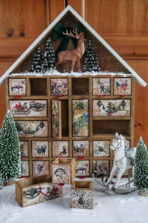 Advent calendar in the shape of a house, with drawers. There are Christmas pictures on the drawers. Under the canopy, a scene with a deer in a snowy forest Unusual Advent Calendar, Advent Calendar Wooden, Handmade Advent Calendar, Advent Calendar House, Christmas Advent Calendar Diy, New Year Calendar, Christmas Shadow Boxes, House Photo, Paper Mache Sculpture