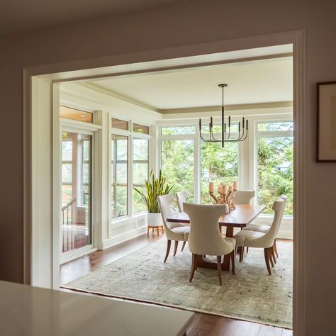 What a difference this addition made to this house, both inside and out! We added about 360 square feet with a new dining room and sun room. . Additions can be tricky, and this one was especially so, with a combination of indoor and semi-outdoor space. With special attention to detail, we designed this addition to be seamlessly integrated with the existing home so that it looks like it's always been there. ______________________________________________ #homeaddition #interior #interiorst... Three Season Porch Dining Room, Deck Off Dining Room, Patio Door In Dining Room, Kitchen Table In Sunroom, Dining Room With A Lot Of Windows, Large Windows Dining Room, Sunroom With Wainscoting, Add On Dining Room To House, Dining Room French Doors To Outside