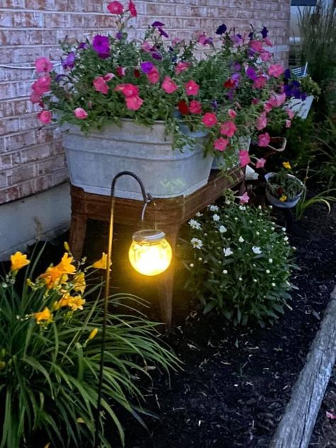 Backyard Corner Gardens, Lake House Flower Bed Ideas, Front Porch Flower Bed Farmhouse, Flower Bed Ideas Side Of House, Curb Appeal For Renters, Container Garden Flower Bed, Country Front Porch Ideas Rustic, Flower Pots In Front Of House, Small Shepherd Hook Ideas