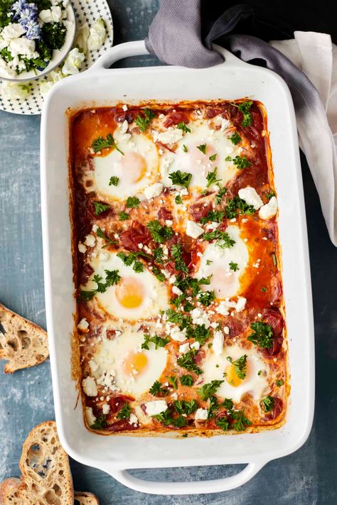 For a simple twist on this traditional Middle Eastern Breakfast, try our easy oven baked shakshuka! It is perfect for your next brunch. Shakshuka In Oven, Shakshuka For A Crowd, Baked Shakshuka Recipe, Sheet Pan Shakshuka, Oven Baked Shakshuka, Oven Shakshuka, Feta Breakfast Recipe, Baked Shakshuka, Oven Breakfast Ideas