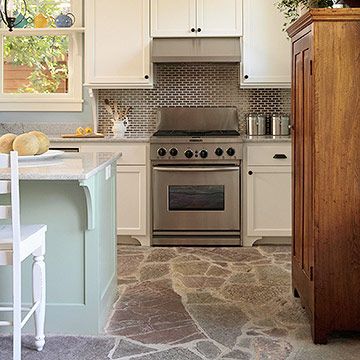 Coastal color and charm can be found throughout this cool, casual kitchen, including underfoot. Rustic flagstone flooring -- in watery blue and green hues -- complements the soft blue of the walls and the soft green of the island base. The flooring is durable and easy to maintain Kitchen Tile Floor, Kitchen Flooring Options, Best Flooring For Kitchen, Casual Kitchen, Kitchen Floor Tiles Ideas, Flagstone Flooring, Rustic Flooring, Natural Stone Flooring, Floor Ideas