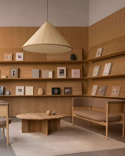 In Copenhagen's historic Ny Østergade, @new_mags has unveiled its flagship store, a quiet oasis designed by @normarchitects , showcasing a curated selection of lifestyle books, collectibles, and magazines. Inspired by the classic library, the design showcases these books as pieces of art, surrounded by carefully selected sculptures and objects. The use of natural materials like oak wood and golden sandstone creates a calm and gentle backdrop, encouraging visitors to delve into the diverse se... Long Study Table, Lifestyle Books, Space Icons, Dragon House, Hospital Interior, Norm Architects, Branding Inspo, Working Space, Store Interior