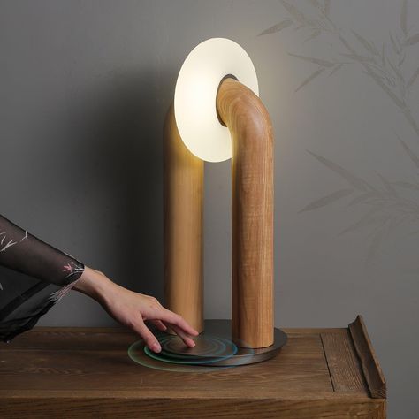 This U-Shaped Xuanguang Table Lamp is both beautiful and practical. It features a Tianmen Xuanguang, an acrylic lampshade, a metal base to enhance load-bearing capacity, and a solid wood lamp body with whole wood carving natural texture. It has a touch switch for easy use and an optical light guide for a soft and natural glow. An excellent combination of form and function. 
 If you have any questions about our products, please contact us and we will get back to you within 24 hours. 
 Original design of the same series of solid wood products, click to learn more>>> 
   Product Size 
 Size: Dia 20cm x   H 45cm /  7.9 x H 17.7 
 
 Details 
 Material:  Wood, Acrylic, Metal. 
 Light source: Integrated LED (LED lights are fully built into the fixture and cannot be replaced). 
 Kelvin range: Warm Beautiful Product Design, Hallway Wall Lights, Metallic Table, Oak Plywood, Metal Lamp Base, Tiffany Style Table Lamps, Arch Light, Arch Lamp, Wood Lamp Design