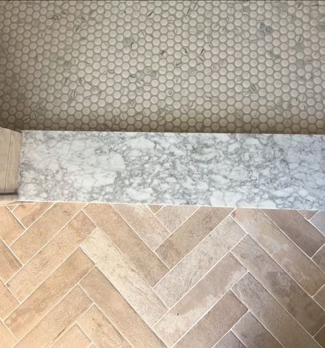 This is one of our favorite transitions! We love the combination of natural herringbone brick leading to a marble threshold and penny tile. Fun fact: using a small patterned tile for a shower floor is essential as it helps maintain the necessary slope for proper drainage. Annapolis interior design. Annapolis real estate. Bathroom remodel. #intudesign Tile Shower Floor Ideas, Tile Shower Floors, Shower Floor Ideas, Penny Tile Shower Floor, Herringbone Brick Floor, Marble Threshold, Herringbone Brick, Brick Floor, Patterned Tile