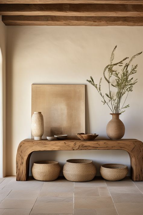 Discover curated charm in our entryway oasis, adorned with a rustic wooden console table, decorative baskets, and minimalist ceramics. Embracing the essence of southern countryside living, this space weaves earthy tones, emotive lighting, and the quaint allure of cottagecore. #CuratedCharm #RusticEntryway #SouthernAppeal #MinimalistDecor #CottagecoreInspiration #EarthTonePalette #DecorativeStools #EmotiveLighting #CountryLiving #HomeDesign Earthy Tones Home Interior, Entryway Organic Modern, Organic Earthy Interiors, Rustic Organic Home Decor, Modern Organic Entryway Ideas, Boho Natural Living Room, Organic Modern Entry, Earthy Tones Interior, Organic Design Interior