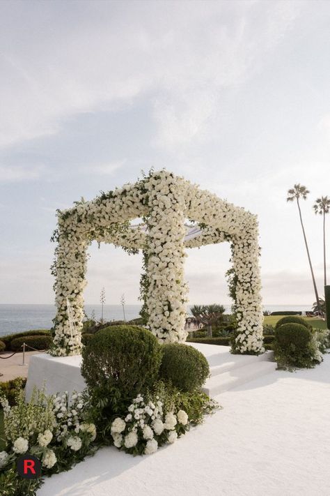 The Chuppah was fully covered in white roses and the aisle was embellished with exquisite white florals and covered with a plush white carpet. ​ ​Our Beverly Hills and Hollywood Collection provided stylish seating for guest during this ceremony. ​Planning and Design - @internationaleventco ​Florist - @marksgarden ​Photographer - @walker.studios ​Lighting - @images_lighting @rayoflighting ​Decor @revelryeventdesign #whitewedding #modernweddingdesign #luxuryweddingdesign #weddingdesign Huppah Wedding, Ceremony Planning, Chuppah Decor, Wedding Chuppah, Purple And Gold Wedding, Dream Wedding Reception, Wedding Hall Decorations, Enchanting Wedding, Enchanted Wedding