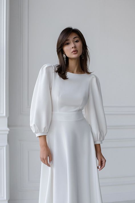 Captivate the room with the ELAGIA White Backless Puff Sleeve Midi Dress. The perfect fusion of sophistication and allure, featuring puff sleeves and a stunning backless design. #whitedress #backlessdress #puffsleeve #midi #ElagiaFashion #sophisticatedstyle #femininecharm #dressfashion #glamorouslook #etherealbeauty High Neck Puff Sleeve Dress, Puff Full Sleeve Dress, White Dress Puffy Sleeves, White Dress For Graduation, Puffy Sleeves Dress, Puffy Sleeve Dress, Graduation Look, Grad Outfits, White Dresses Graduation