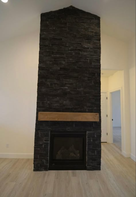 Black Stone Fireplace With Built Ins, Black Stone Veneer Fireplace, Black Stone Outdoor Fireplace, Black Ledger Stone Fireplace, Black Stack Stone Fireplace, Black Stone For Fireplace, Stone Fireplace Makeover Black, Dark Stone Fireplace Ideas, Black Wood Burning Fireplace