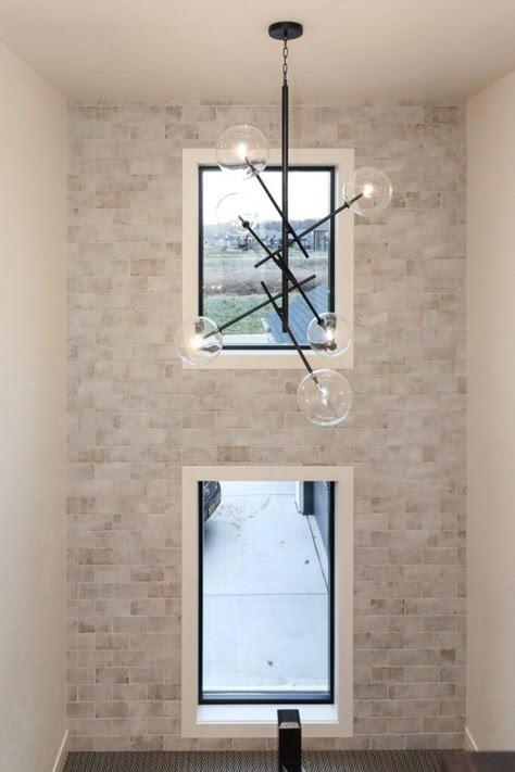 White brick accent wall in staircase. Modern Brick Accent Wall, Brick Accent Wall Entry Way, Light Brick Accent Wall, Brick Staircase Wall, Faux Brick Wall Staircase, Stairway Accent Wall With Window, Brick Accent Wall Staircase, Brick Wall Staircase, Accent Staircase Wall