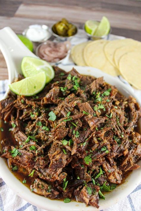 Dutch Oven Barbacoa is an easy way to make this extremely flavorful shredded beef! Serve in tacos, enchiladas, nachos or even in Beef & Noodles. You'll love the spicy chili sauces that every bite is drenched in! Carne Asada Recipes Dutch Oven, Beef Carnitas Dutch Oven, Barbacoa Beef Recipe, Barbacoa Dutch Oven Recipe, Dutch Oven Mexican Beef, Shredded Beef Dutch Oven, Beef Barbacoa Dutch Oven, Dutch Oven Tacos, Mexican Shredded Beef Dutch Oven