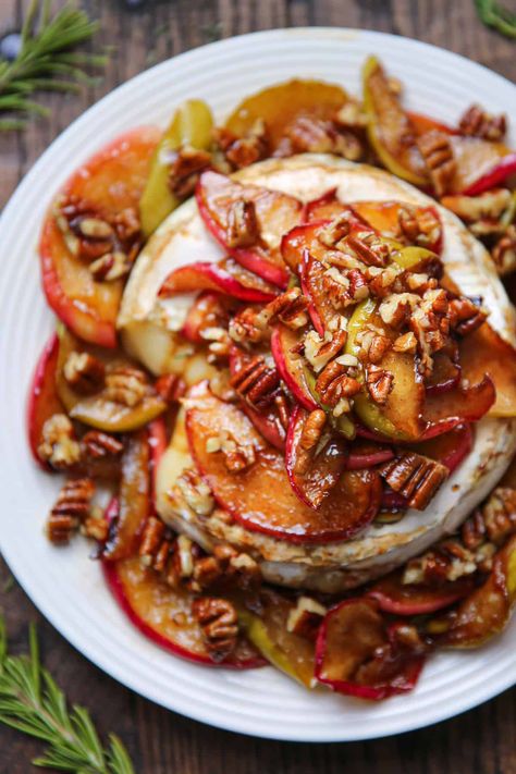 baked brie with apples and pecans on a white plate Baked Brie With Apples, Brie With Apples, Caramel Apple Dessert, Warm Brie, Apples With Cinnamon, Brie Cheese Recipes, Caramel Dessert, Baked Brie Recipes, Caramelized Apples