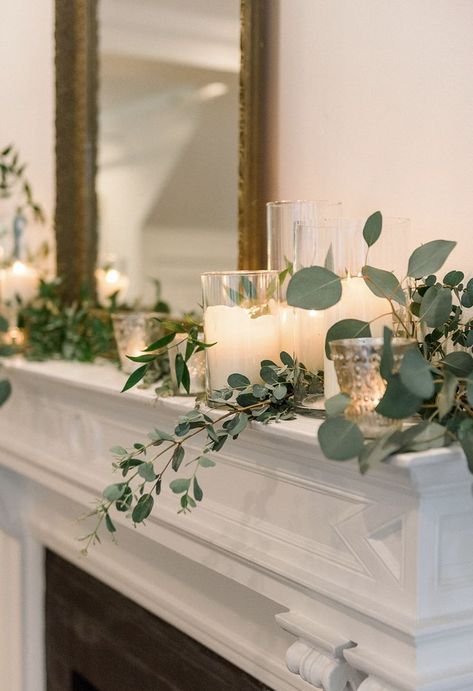 Lanterns With Candles And Greenery, Eucalyptus On Mantle, Wedding Fireplace Candles, Candle Mantle Decor Wedding, Eucalyptus Fireplace Mantle, Mantle Decorating Ideas Wedding, Flower Mantle Decor, Candles On A Mantle, Decorating A Fireplace For A Wedding