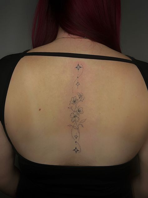 Fine line back tattoo flower tattoo Fine Line Girly Tattoos, Cherry Blossom Spine Tattoos For Women, Floral Fine Line Spine Tattoo, Spine Fine Line Tattoo, Lilly Spine Tattoo, Dainty Flower Spine Tattoo, Fine Line Tattoo Spine, Back Tattoo Fine Line, Cherry Blossom Spine Tattoo