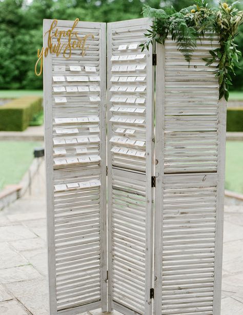 Grey Shutter Screen with "Find Your Seat" gold acrylic sign, available to hire for weddings and events. Perfect for a creating a beautiful shutter seating plan | From: Vanilla Rose Weddings, Oxfordshire, UK. Photography: Julie Michaelsen Shutters Seating Chart, Party Rental Ideas, Wedding Planners, Wedding Display, Cotswolds Wedding, Reception Seating, Wedding Table Plan, Countryside Wedding, Beach Wedding Favors