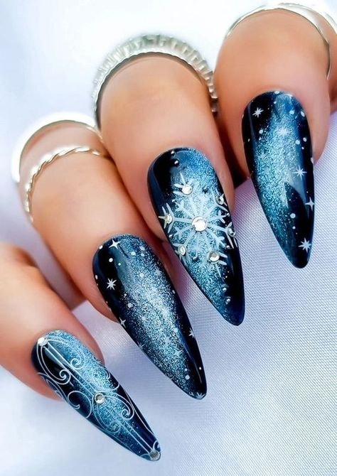 Discover 17 blue Christmas nails for 2024-2025, perfect for winter with stunning glitter, matte, and sparkle designs. These nails are ideal for almond, oval, square, and coffin shapes, offering a chic look with winter sparkle. Whether you prefer short acrylics or natural nails, these designs combine bling, light and dark blues, and elegant white accents to make your holiday season shine. Pretty Nails For Christmas, Christmas Nails White And Blue, Blue Christmas Nail Art, Frosty Winter Nails, Blue Black White Nails, Winter Blue Nail Designs, Nails Winter Design, Christmas Blue Nails, Black Blue Nails