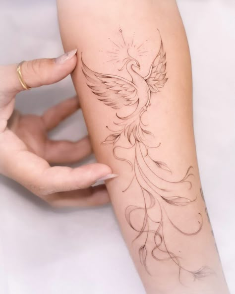 20 Phoenix Tattoos To Inspire Strength And Hope For Better Days Ahead I Will Rise Tattoo Ideas, Phoenix Tattoo Feminine Hand, Delicate Phoenix Tattoos For Women, Sunflower Phoenix Tattoo, Phoenix And Compass Tattoo, Phoenix Henna Design, Art Deco Tattoos For Women, Phonex Tattoo Meaning, Phoenix Half Sleeve Tattoo For Women