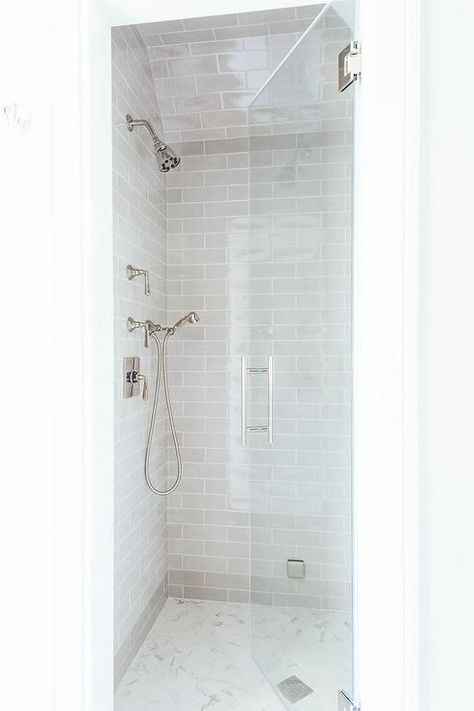 Small walk in shower features gray subway tiles on ceiling and walls lined with a hand held polished nickel shower kit over a white marble herringbone shower floor finished with a seamless glass shower door. Small Shower Remodel, Small Shower, Small Showers, Bad Inspiration, Camper Remodel, Diy Bathroom Remodel, Bathroom Remodel Shower, Trendy Bathroom, Bath Room